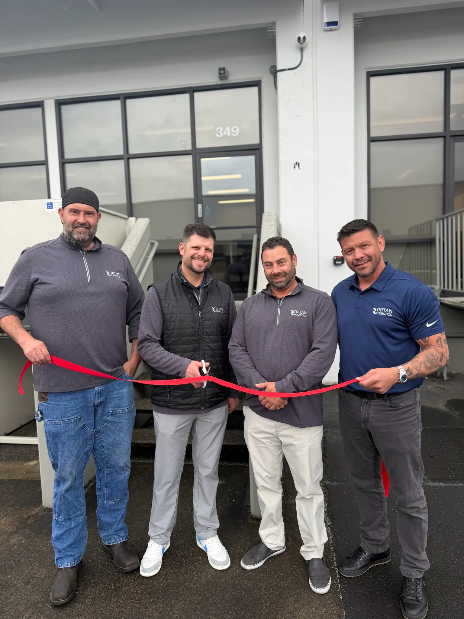 Mike Crabb, Matt Hodson, Marshall Nachtman, and Jamie Ponsaran celebrating the May 11 Tritan Logistics Group ribbon cutting at the new Tukwila, Washington facility at 349 / 351 Upland Drive.